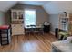 Spacious carpeted bonus room features light hardwood flooring, cabinets, a desk, and shelving at 4330 Goodman Lake Rd, Salisbury, NC 28146