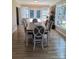 Formal dining room boasts hardwood floors, an elegant table setting, and a view of the fireplace and outdoor scenery at 4330 Goodman Lake Rd, Salisbury, NC 28146