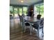 Inviting dining room with hardwood floors, table with six chairs, and ample natural light from large windows at 4330 Goodman Lake Rd, Salisbury, NC 28146