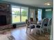 Inviting dining room with hardwood floors, brick fireplace, and ample natural light from large windows at 4330 Goodman Lake Rd, Salisbury, NC 28146