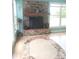 Inviting fireplace with hardwood floors, oval rug, and ample natural light from large windows at 4330 Goodman Lake Rd, Salisbury, NC 28146