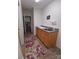 Hallway view of a utility sink with cabinets and an eye-catching floral rug at 4330 Goodman Lake Rd, Salisbury, NC 28146