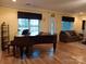Living room with wood floors, a piano, and lots of natural light at 4330 Goodman Lake Rd, Salisbury, NC 28146