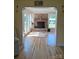 Cozy living room boasts a brick fireplace, access to a sunroom, and hardwood floors for a warm and inviting ambiance at 4330 Goodman Lake Rd, Salisbury, NC 28146