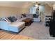 Carpeted Living room with a sectional, ceiling fans, and a glimpse into another room at 4330 Goodman Lake Rd, Salisbury, NC 28146