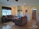 Bright living room features hardwood floors, and comfortable seating with decor shelving, for a cozy and inviting atmosphere at 4330 Goodman Lake Rd, Salisbury, NC 28146