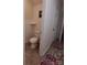 Small bathroom with a toilet and white walls with decorative artwork at 4330 Goodman Lake Rd, Salisbury, NC 28146