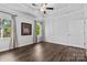 Light-filled bedroom with hardwood floors, neutral walls, and a ceiling fan at 4607 Walking Path Dr, Waxhaw, NC 28173