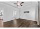 Well lit Bedroom featuring a decorative ceiling, light hardwood floors, and ensuite bathroom at 4607 Walking Path Dr, Waxhaw, NC 28173