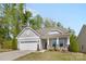 Charming single-story home with a well-manicured lawn, beautiful landscaping, and a two-car garage at 4607 Walking Path Dr, Waxhaw, NC 28173