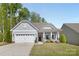 Charming single-story home with a manicured lawn, attached two car garage and welcoming front porch at 4607 Walking Path Dr, Waxhaw, NC 28173