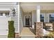 Inviting front porch with stone column bases and a decorative wreath on the front door at 4607 Walking Path Dr, Waxhaw, NC 28173