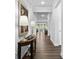 Hallway with dark wood floors leading to the living area, complemented by elegant lamps and decor at 4607 Walking Path Dr, Waxhaw, NC 28173
