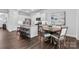 Open kitchen featuring a large island with seating and adjacent dining area at 4607 Walking Path Dr, Waxhaw, NC 28173