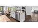 Open concept kitchen with a large island, stainless appliances, and view of the living area at 4607 Walking Path Dr, Waxhaw, NC 28173