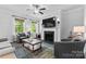 Comfortable living room featuring a fireplace with mantel, ceiling fan, and stylish furniture on a decorative rug at 4607 Walking Path Dr, Waxhaw, NC 28173