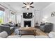 Bright living room featuring modern ceiling fan, stylish furniture, a fireplace, and a decorative rug at 4607 Walking Path Dr, Waxhaw, NC 28173