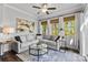 Bright living room featuring modern ceiling fan, stylish sofa, and lots of natural light at 4607 Walking Path Dr, Waxhaw, NC 28173