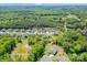 Aerial shot of a neighborhood with manicured lawns, wooded areas, and a home with a putting green at 5028 Whitemarsh Ct, Indian Land, SC 29720
