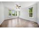 Bright bedroom with hardwood floors, ample natural light, and a ceiling fan, creating a comfortable space at 5028 Whitemarsh Ct, Indian Land, SC 29720