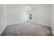 Cozy bedroom features plush carpeting and a window offering natural light at 5028 Whitemarsh Ct, Indian Land, SC 29720