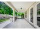 A covered patio featuring a built-in grill and stone countertop overlooking a private backyard at 5028 Whitemarsh Ct, Indian Land, SC 29720