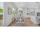 Bright dining area featuring wood table and chairs, beverage storage rack, and modern chandelier lighting at 5028 Whitemarsh Ct, Indian Land, SC 29720
