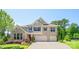 Beautiful two-story home featuring manicured landscaping, a two-car garage, and neutral brick facade at 5028 Whitemarsh Ct, Indian Land, SC 29720