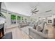 Bright open living room with fireplace, neutral decor, large sectional, and windows overlooking the yard at 5028 Whitemarsh Ct, Indian Land, SC 29720