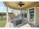 Back porch with wicker chairs, coffee table, and a ceiling fan at 5037 Nighthawk Dr, Fort Mill, SC 29707