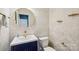 Powder room features a navy vanity, gold fixtures, and a round mirror with patterned wallpaper at 5037 Nighthawk Dr, Fort Mill, SC 29707