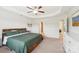 Bedroom featuring a tray ceiling, ceiling fan, & ensuite bathroom with laundry at 5037 Nighthawk Dr, Fort Mill, SC 29707
