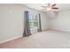 Bright bedroom with a ceiling fan, plush carpet, and a window offering scenic views at 5037 Nighthawk Dr, Fort Mill, SC 29707