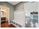 Entryway with storage bench leading to half bathroom and kitchen with hardwood floors at 5037 Nighthawk Dr, Fort Mill, SC 29707