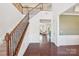 Bright foyer with hardwood floors, staircase with wrought iron railings, and views into the living areas at 5037 Nighthawk Dr, Fort Mill, SC 29707