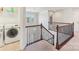 Hallway with a staircase, laundry area, and white walls, offering ample space and functionality at 5037 Nighthawk Dr, Fort Mill, SC 29707