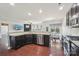 The open kitchen features dark cabinets, stainless steel appliances, and a breakfast nook with a view to living room at 5037 Nighthawk Dr, Fort Mill, SC 29707