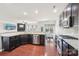 The open kitchen features dark cabinets, stainless steel appliances, and a breakfast nook with a view to living room at 5037 Nighthawk Dr, Fort Mill, SC 29707