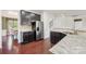 The kitchen features dark cabinets, granite countertops, stainless steel appliances, and hardwood floors at 5037 Nighthawk Dr, Fort Mill, SC 29707