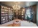 Unique library features a chandelier, built-in bookshelves, a hammock chair, and a plush ottoman at 5037 Nighthawk Dr, Fort Mill, SC 29707