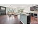 Open-concept living room and kitchen area boasts hardwood floors, a fireplace, and stainless steel appliances at 5037 Nighthawk Dr, Fort Mill, SC 29707
