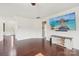 Bright living room with hardwood floors, a fireplace, and a large TV at 5037 Nighthawk Dr, Fort Mill, SC 29707