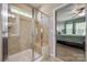 Ensuite bathroom with glass shower, tile surround, bench and bedroom access at 5050 Kinross Ln, Indian Land, SC 29707