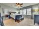 Relaxing bedroom with ample windows, decorative curtains, fan and wall art at 5050 Kinross Ln, Indian Land, SC 29707