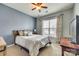 Bright bedroom with textured walls, ceiling fan, plush carpet, and natural light at 5050 Kinross Ln, Indian Land, SC 29707