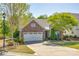 Charming home featuring brick facade, attached garage, manicured landscaping, and a welcoming front entryway at 5050 Kinross Ln, Indian Land, SC 29707