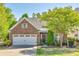 Charming brick home featuring a well-maintained front yard and attached garage at 5050 Kinross Ln, Indian Land, SC 29707