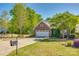 Charming home featuring brick accents, attached garage, manicured landscaping, and a welcoming front entryway at 5050 Kinross Ln, Indian Land, SC 29707