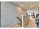Upstairs hallway with carpet flooring, wood handrail, neutral walls, and natural light at 5050 Kinross Ln, Indian Land, SC 29707