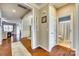 Bright hallway featuring hardwood floors, a welcome sign, and access to a bathroom at 5050 Kinross Ln, Indian Land, SC 29707